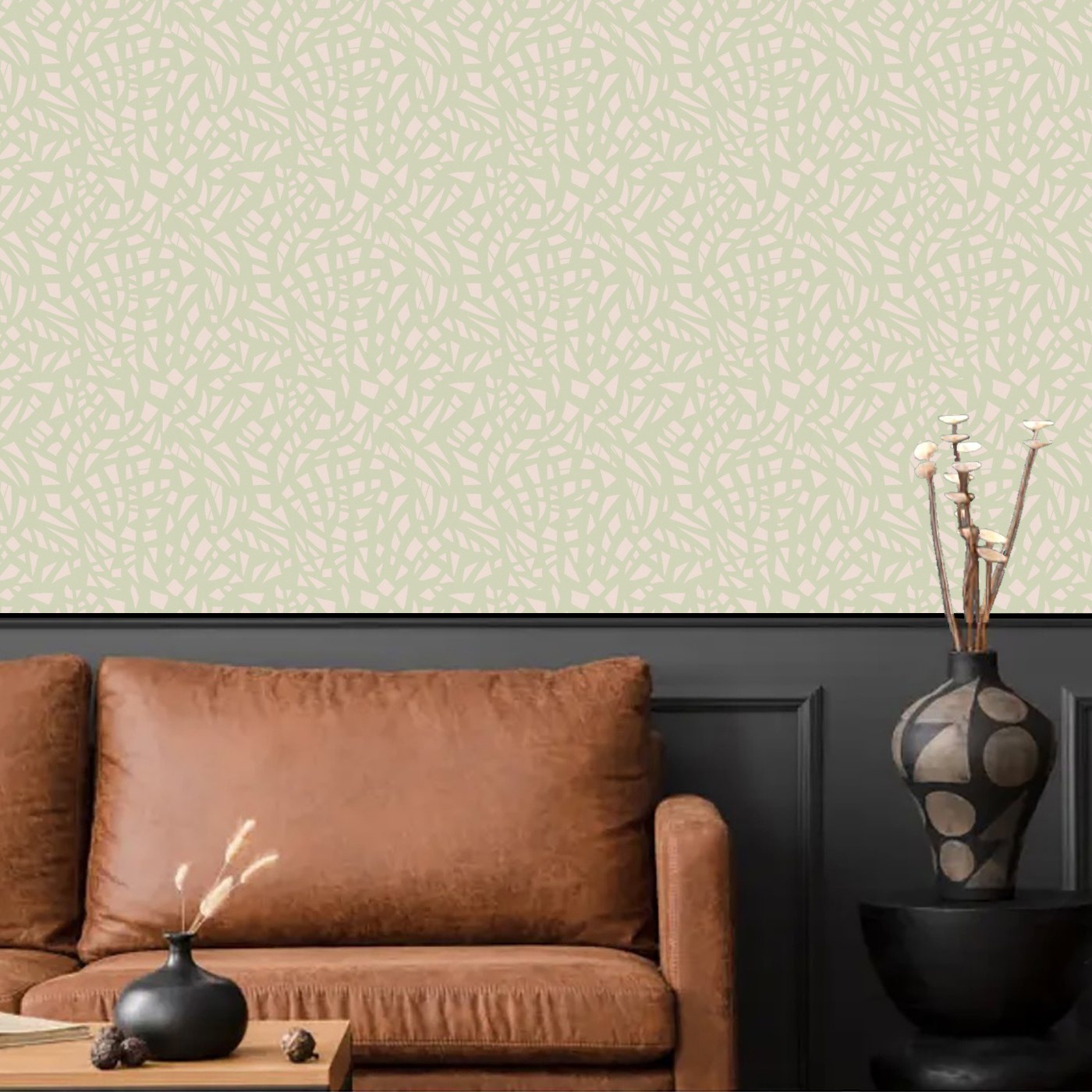 Shattered Small wallpaper in soft sage green on a sunlit wall behind a wooden sideboard
